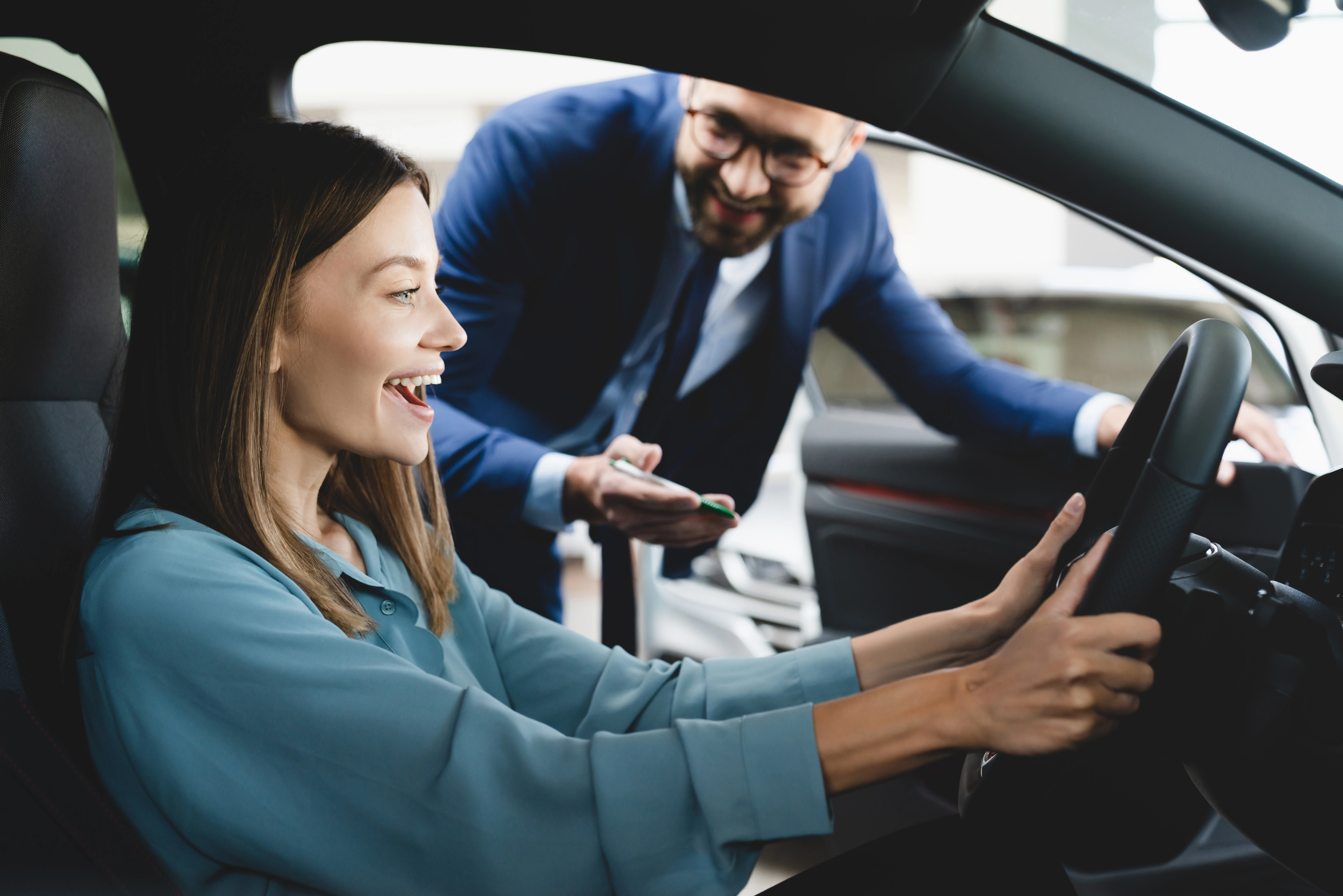 Happy woman getting new lease car